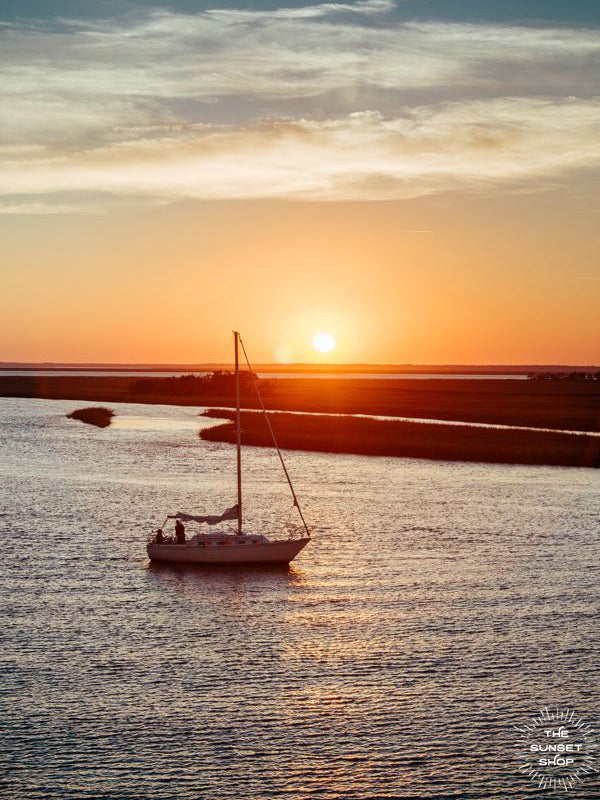 There&#39;s nothing quite like being the captain of your own vessel, harnessing the power of the wind, gliding across the water, and going whichever course your heart desires. Especially after a glorious day sailing and coming in to dock during sunset over the marsh! Sunset over the marsh in Savannah, Georgia photographed by Kristen M. Brown of Samba to the Sea for The Sunset Shop.