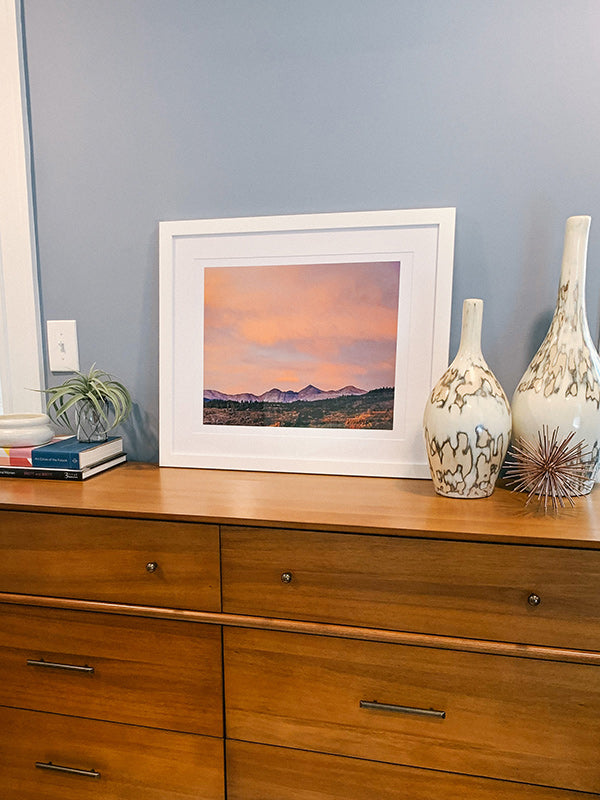 Sunset alpenglow mountain print on midcentury modern dresser. Sunset image of Alpenglow on Arapahoe, Gray, and Torrey mountains, Colorado. "Arapahoe Glow" mountain sunset image print by Kristen M. Brown, Samba to the Sea. 