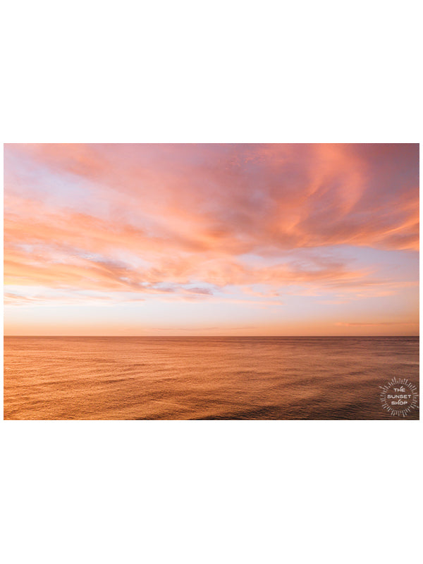 Aerial photo of a vibrant pink sunset casting a pink glow on the ocean in Playa Avellanas Costa Rica. By Kristen M. Brown of Samba to the Sea at The Sunset Shop.