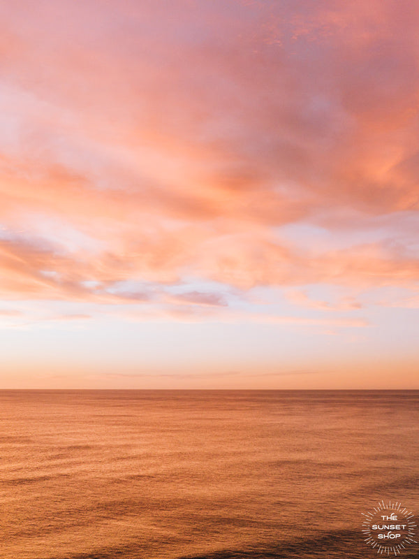 Aerial photo of a vibrant pink sunset casting a pink glow on the ocean in Playa Avellanas Costa Rica. By Kristen M. Brown of Samba to the Sea at The Sunset Shop.