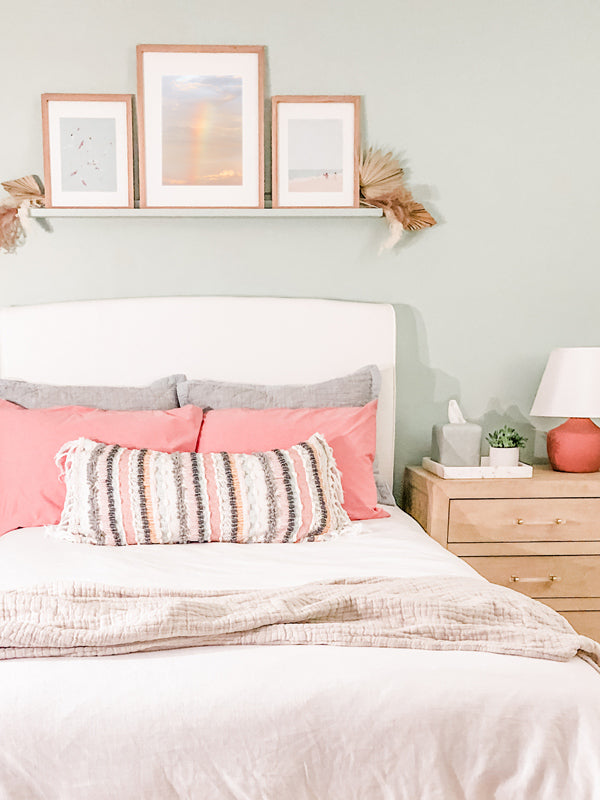 Rainbow photo print hanging in teenager's boho beach surf shack bedroom. Pastel sunset rainbow photo print "Baby Bow" photographed by Kristen M. Brown of Samba to the Sea for The Sunset Shop.