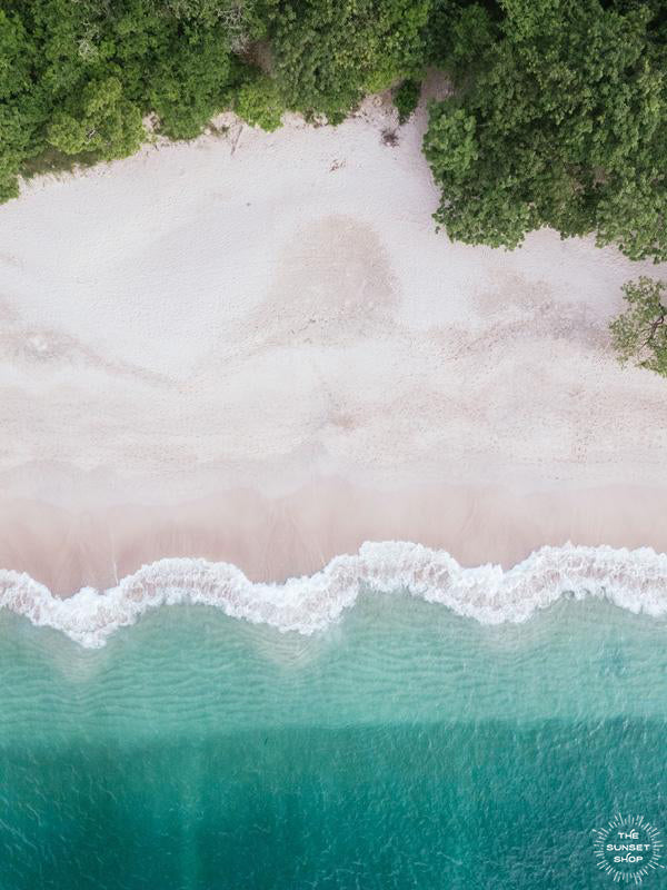 Aerial image of white sand beach and turquoise water of the beach at Playa Conchal, Costa Rica. Aerial beach print by Samba to the Sea at The Sunset Shop. Coastal living large wall art framed aerial beach print.