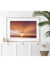 White tropical coastal living room with gorgeous sunset photography print. Tamarindo Costa Rica breathtaking sunset with the suns rays breaking through the clouds in Costa Rica. Photo by Kristen M. Brown, Samba to the Sea for The Sunset Shop.