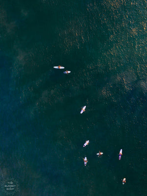 There's nothing quite like paddling out and sharing waves with your friends. Now that's your kind of board meeting! 🌊 Aerial image of surfers in ocean in Costa Rica by Samba to the Sea at The Sunset Shop.