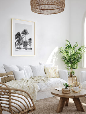 White boho rattan living room with black and white palm tree photography print of Key Biscayne, Florida. Fine Art Photos by Kristen M. Brown of Samba to the Sea for The Sunset Shop.