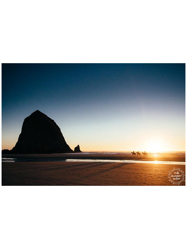 Horseback ride on the beach in Cannon Beach, Oregon during a golden sunset. Horseback riding on the beach by Haystack Rock. "Cannon Beach Gold" golden beach sunset print by Kristen M. Brown, Samba to the Sea.