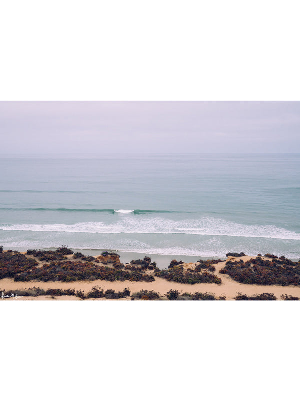 "Del Mar Dreaming" photo print of wave breaking in the hazy early morning marine layer in Del Mar, CA by Kristen M. Brown of Samba to the Sea for The Sunset Shop. Ocean photo print in boho modern coastal living room.