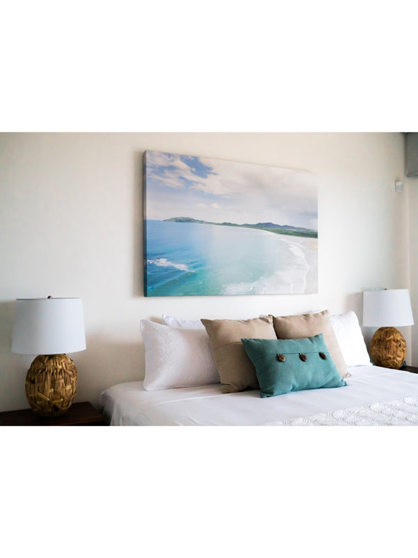 Aerial canvas print of the the beach in Tamarindo Costa Rica hanging in a luxury rental home in Tamarindo, Costa Rica called Angel Del Mar. Drone image of turquoise ocean water and surfers. Aerial beach print by Samba to the Sea at The Sunset Shop.