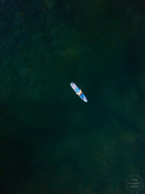 Close your eyes and transport yourself back to your happy place, sitting on your surfboard in the warm ocean, waiting for the the next wave to roll through. Aerial surfer girl photo in Costa Rica by Samba to the Sea at The Sunset Shop.