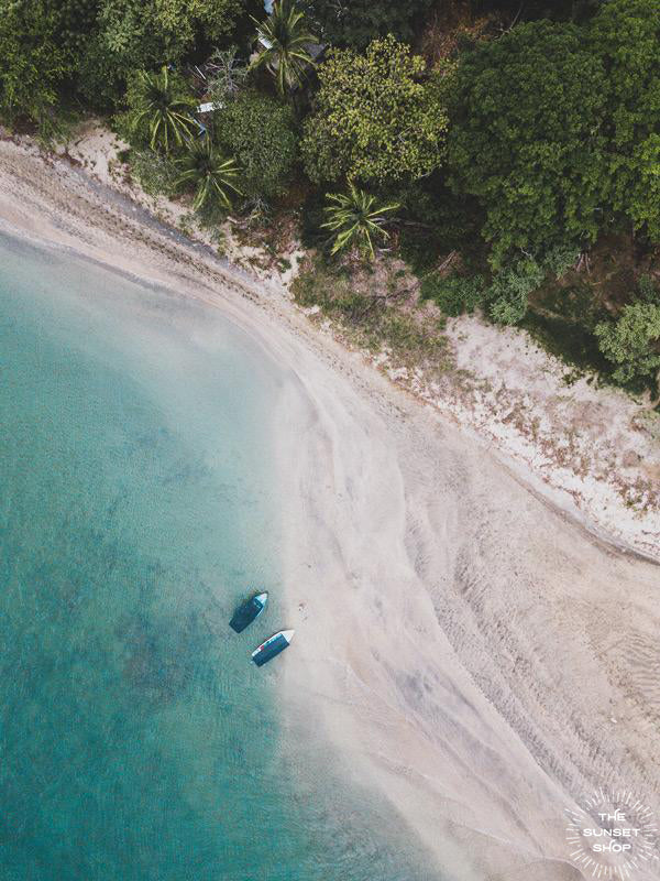 Tamarindo Costa Rica estuary. Aerial image of turquoise water, white sand beach, boats, and palm trees. Aerial beach print by Samba to the Sea at The Sunset Shop.