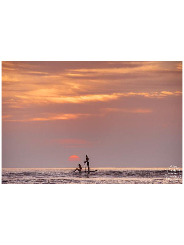 Let's go somewhere the sun kisses the ocean. Stand up paddle boarder couple watching sunset from the Pacific Ocean in Tamarindo Costa Rica. Photographed by Kristen M. Brown, Samba to the Sea for The Sunset Shop.