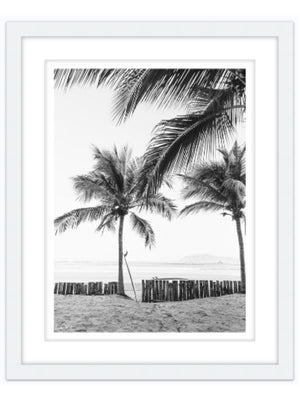 Instantly transport yourself to your surf paradise with this black and white image of your surfboards - your magic sticks - patiently waiting under palm trees for you and your surf amigo/a to paddle out! Black and white image of two Robert August surfboards waiting to paddle out while laying under palm trees in Costa Rica. "Magic Sticks" palm tree surf print photographed by Kristen M. Brown of Samba to the Sea for The Sunset Shop.