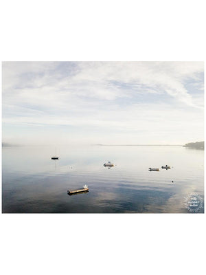 Morning Magic. Fog rolling in over Huntington Bay on the North Shore of Long Island. Aerial image of boats anchored in the bay during a calm, foggy early morning in Huntington, NY. Photographed by Kristen M. Brown, Samba to the Sea.