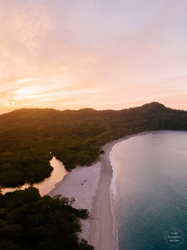 "New Year Magic" aerial sunset print by Samba to the Sea at The Sunset Shop. Image is an aerial photo of sunset over the beach in Playa Conchal, Costa Rica.