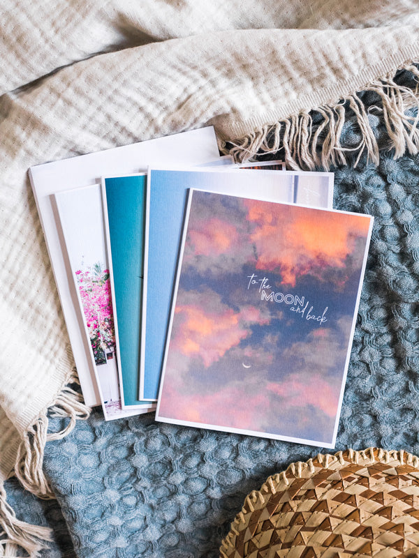 "To the Moon and Back" notecard. What's better than a text message from a loved one? Happy mail from a loved one! 📫💌 Grab this dreamy set of four notecards printed on divine linen card stock (blank inside) and start sending some love notes to your mom, boyfriend/girlfriend, best friend...and of course your grandma! By Kristen M. Brown, Samba to the Sea for The Sunset Shop.