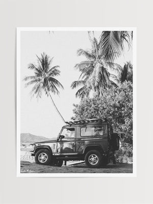 Nothing quite comes close to evoking that feeling that a tropical beach adventure is about to happen than a Land Rover Defender. So what are you waiting for? Hop on in and adventure away to find your tropical beach paradise! "Paradise Found Rover" black and white Land Rover Defender beach and palm trees photo print by Kristen M. Brown of Samba to the Sea for The Sunset Shop.