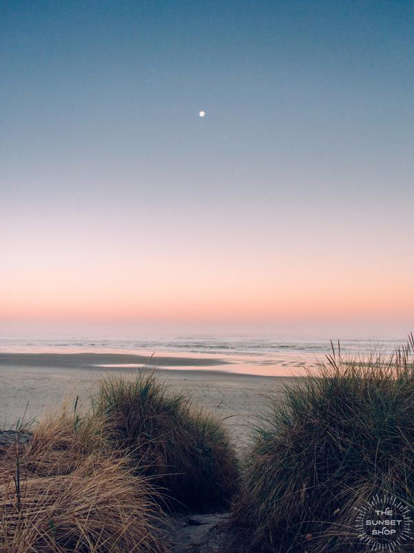 Full moon setting during a pastel pink sunrise on the Oregon Coast. "Pink Side of the Moon" sunrise beach print by Kristen M. Brown, Samba to the Sea.