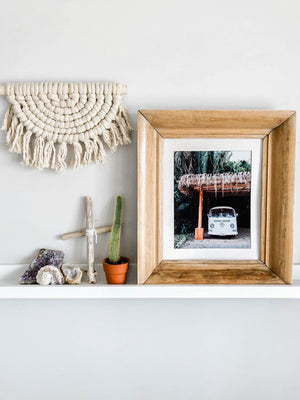 Life is simple - - surf 🏄🏼‍♀️ , jam 🎸, live life in a VW Van 🚌 . Channel those carefree, summertime beach days at home with this tropical VW bus print in Nosara, Costa Rica.  Pura Vida Bus print by Kristen M. Brown, Samba to the Sea. Boho coastal living framed beach print shelfie on white shelf.