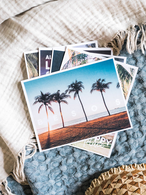 "Besos" Costa Rica postcard. What's better than a text message from a loved one? Happy mail from a loved one! 📫💌 Grab this dreamy set of five postcards printed on 100% recycled card stock and start sending (or leaving in their bag!) some happy mail postcards to your mom, boyfriend/wife/significant other, best friend...and of course your grandma! By Kristen M. Brown, Samba to the Sea for The Sunset Shop.