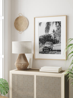 Surf photography vintage Land Cruiser wall art in tropical neutral room. Down a dirt road in Costa Rica lies perfect waves just waiting for you to paddle out --  hop on in to this gorgeous, vintage Toyota Land Cruiser FJ40 and let's roll! "Scenic Route" black and white Land Cruiser photo print of surfboards racked on a vintage Toyota FJ40 photographed by Kristen M. Brown of Samba to the Sea @ The Sunset Shop.