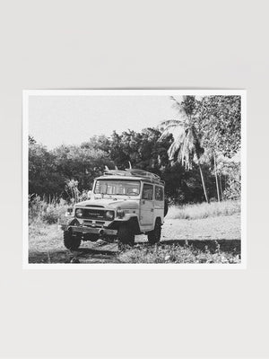 Down a dirt road in Costa Rica lies perfect waves just waiting for you to paddle out --  hop on in to this gorgeous, vintage Toyota Land Cruiser FJ40 and let's roll! "Scenic Route" black and white Land Cruiser photo print of surfboards racked on a vintage Toyota FJ40 photographed by Kristen M. Brown of Samba to the Sea @ The Sunset Shop.
