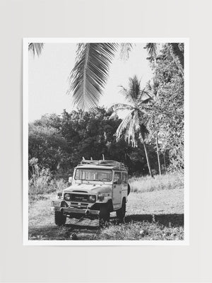 Down a dirt road in Costa Rica lies perfect waves just waiting for you to paddle out --  hop on in to this gorgeous, vintage Toyota Land Cruiser FJ40 and let's roll! "Scenic Route" black and white Land Cruiser photo print of surfboards racked on a vintage Toyota FJ40 photographed by Kristen M. Brown of Samba to the Sea @ The Sunset Shop.