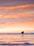 She's Magic sunset surfer print by Samba to the Sea at The Sunset Shop. Photo of a female surfer walking on the beach during a pastel pink sunset in Tamarindo, Costa Rica.