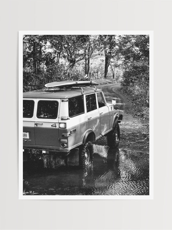 Over a river and down a dirt back road dirt lies a dreamy, peeling wave that only you and your surf amigos know about. You hear a new swell is on the way, so you message your friends to meet you at your secret spot, hop in your vintage Land Cruiser series 55, and surf the day away with just your surf amigos. Welcome back to your surf dream, all from the comfort of your home...wherever home may be with black and white photo print “Surf Cruiser". By Kristen M. Brown of Samba to the Sea @ The Sunset Shop.
