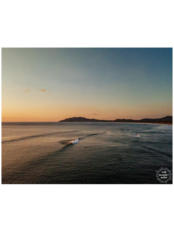 Aerial wave print by Samba to the Sea at The Sunset Shop. Image is an aerial photo of a wave breaking in Tamarindo, Costa Rica.