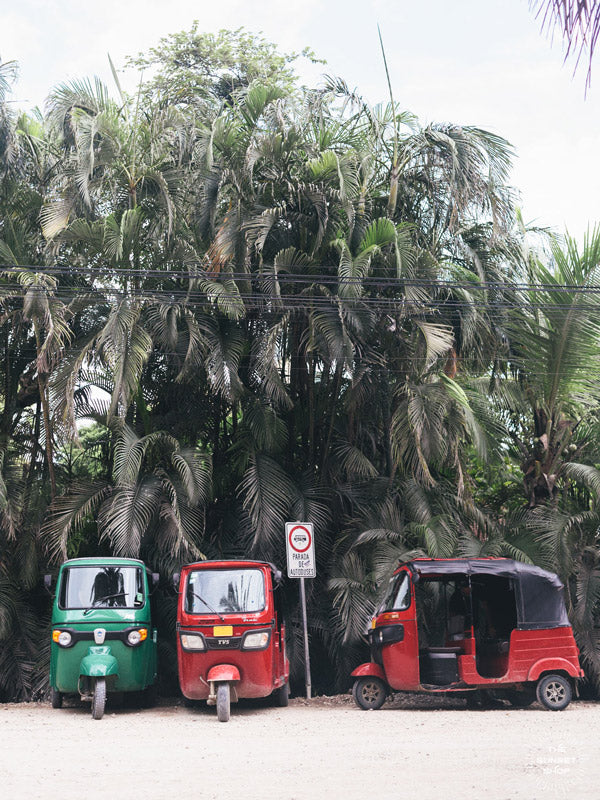 Tuk tuks in Nosara Costa Rica. Where the jungle meets the sea, there lies a boho beach town. You can surf at dawn, practice yoga at sunset, and ride around town via tuk tuk. Welcome to paradise in Nosara (Playa Guiones), Costa Rica. &quot;Tuk Tukking&quot; Photographed by Samba to the Sea for The Sunset Shop.