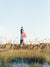 There she was, dancing in the sea breeze with the sea grass and shimmering in the late afternoon sun! Majestic American flag hanging from the Tybee Island Lighthouse in Tybee Island, GA. "Tybeautiful" photographed by Kristen M. Brown, Samba to the Sea for The Sunset Shop.