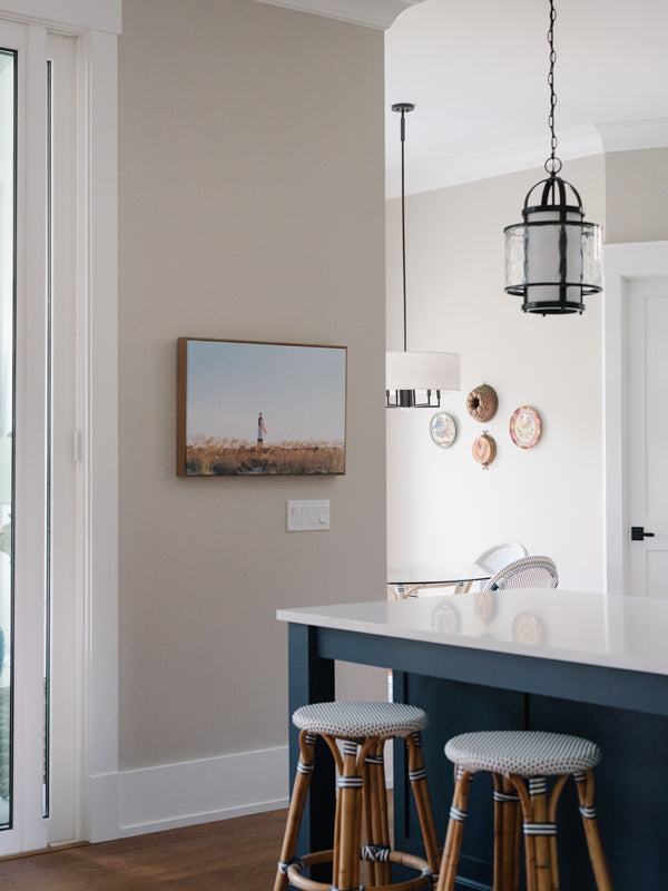 American flag hanging from the Tybee Island Lighthouse in Tybee Island, GA. "Sweet Liberty" photographed by Kristen M. Brown, Samba to the Sea for The Sunset Shop. Coastal Americana home wall art in kitchen.