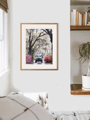 Land Rover photo print wall art. You just know that an adventure is calling when it's that time of year with Savannah's azaleas are vibrantly blooming. So hop on in to this dreamy white Land Rover Defender and experience the magic that is Savannah in full bloom. " 'Venture Rover" Land Rover photo print by Kristen M. Brown of Samba to the Sea for The Sunset Shop.