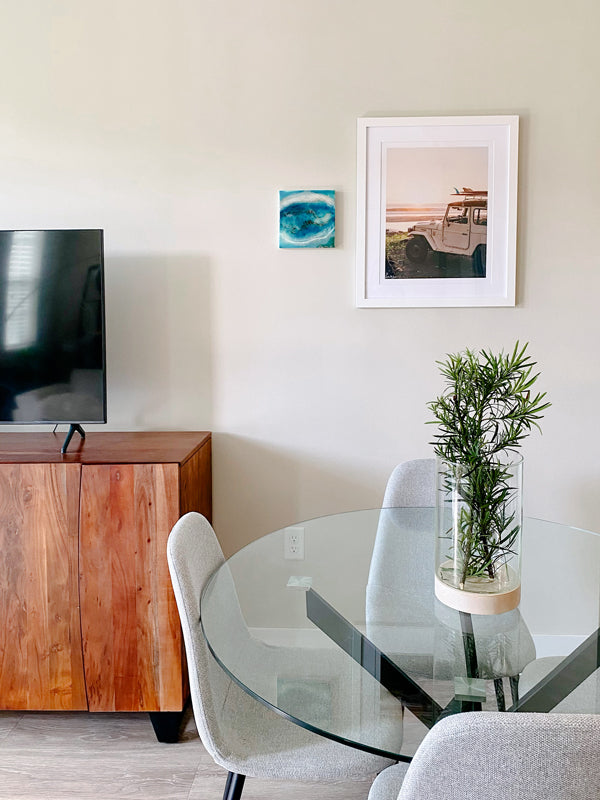 Vintage Land Cruiser FJ40 wall art in living room. "Seek and You Will Find" photo print of vintage Toyota FJ40 Land Cruiser racked up with surfboards parked at the beach in Costa Rica as the waves peel and the sun kissing the horizon turns everything golden. Photographed by Costa Rica photographer Kristen M. Brown of Samba to the Sea for The Sunset Shop.