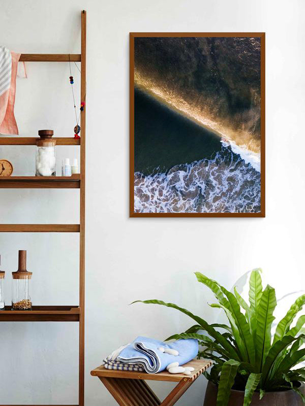 Aerial surfer print by Samba to the Sea at The Sunset Shop. Image is an aerial photo of surfer dropping in on a wave in Tamarindo, Costa Rica.