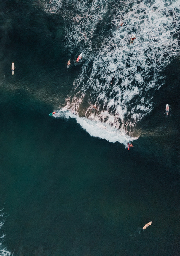 You Go Left and I'll Go Right aerial surfer print by Samba to the Sea at The Sunset Shop. Image is an aerial photo of surfer's splitting the peak in Tamarindo, Costa Rica.