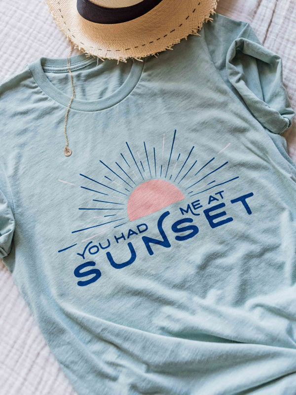 "What's your favorite color?" he asked  "Sunset." she replied.  There's nothing like ending the day watching the sun pass over horizon, painting the sky in magical colors...and now you can show your love for all things sunset with this super comfy, relaxed fit graphic tee "You Had Me At Sunset"! By Samba to the Sea at The Sunset Shop.
