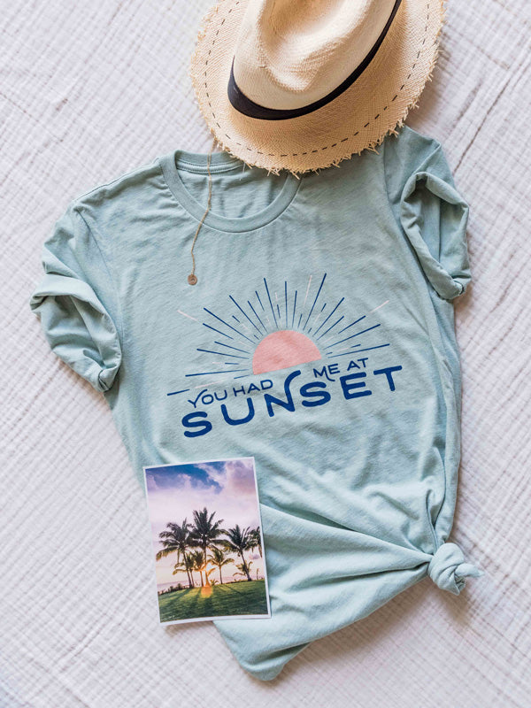 &quot;What&#39;s your favorite color?&quot; he asked  &quot;Sunset.&quot; she replied.  There&#39;s nothing like ending the day watching the sun pass over horizon, painting the sky in magical colors...and now you can show your love for all things sunset with this super comfy, relaxed fit graphic tee &quot;You Had Me At Sunset&quot;! By Samba to the Sea at The Sunset Shop.