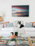 Beautiful beach sunset print in a boho chic living room with a Lulu and Georgia rug. You Had Me At Sunset fine art print by The Sunset Shop, Samba to the Sea.